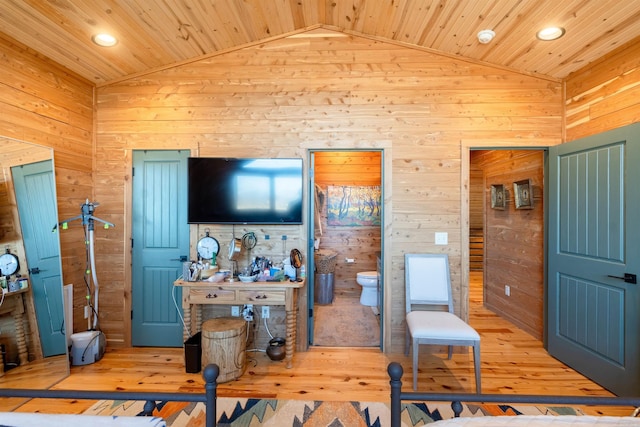 living room featuring wood ceiling, vaulted ceiling, and wooden walls