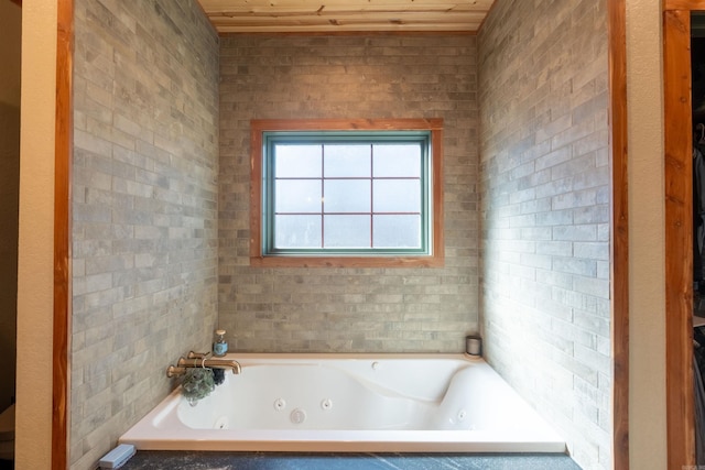 full bathroom with a tub with jets and wooden ceiling