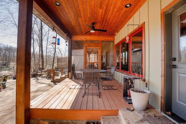 wooden deck featuring ceiling fan and outdoor dining area