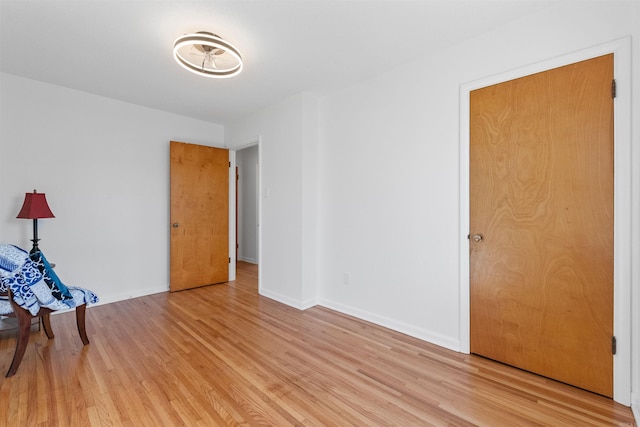 empty room featuring light wood-style flooring and baseboards