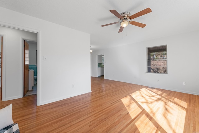 interior space featuring light wood finished floors, ceiling fan, and baseboards