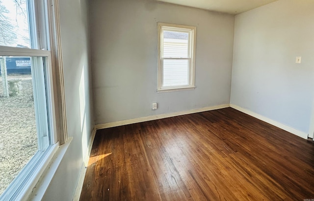 empty room featuring wood finished floors and baseboards