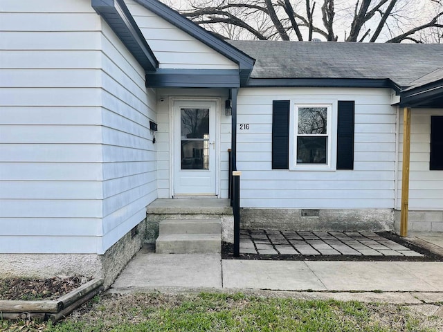 property entrance with crawl space and a shingled roof