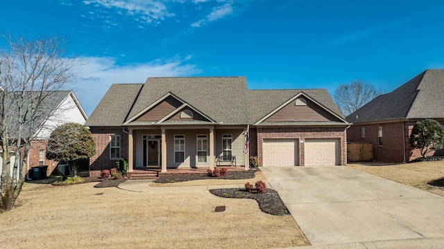 view of front facade featuring an attached garage, covered porch, concrete driveway, and brick siding