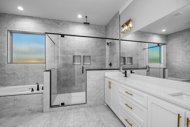 bathroom with double vanity, visible vents, a bath, a shower stall, and a sink