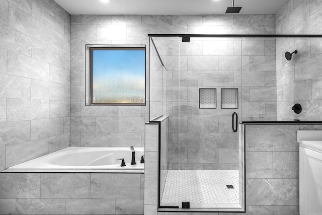 bathroom featuring a garden tub and a shower stall