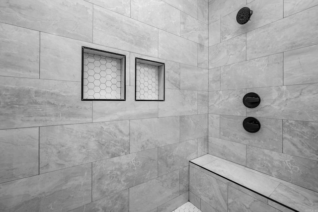 full bathroom with a tile shower