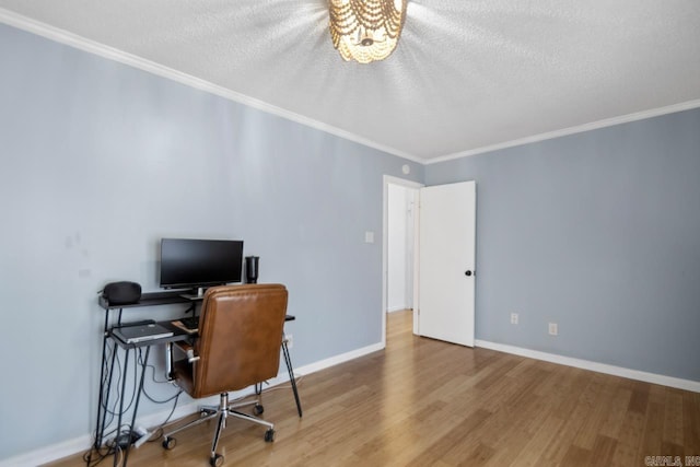 office area featuring baseboards, a textured ceiling, ornamental molding, and wood finished floors