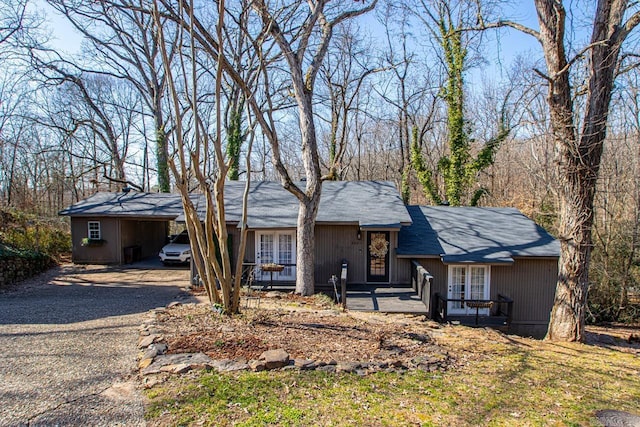 view of front of house featuring a carport, french doors, and driveway