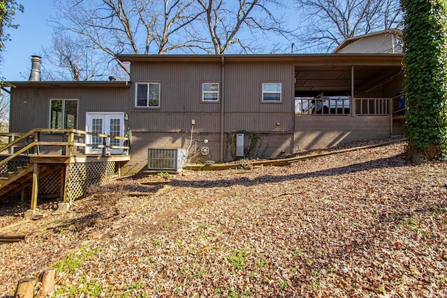 back of house with cooling unit and a wooden deck