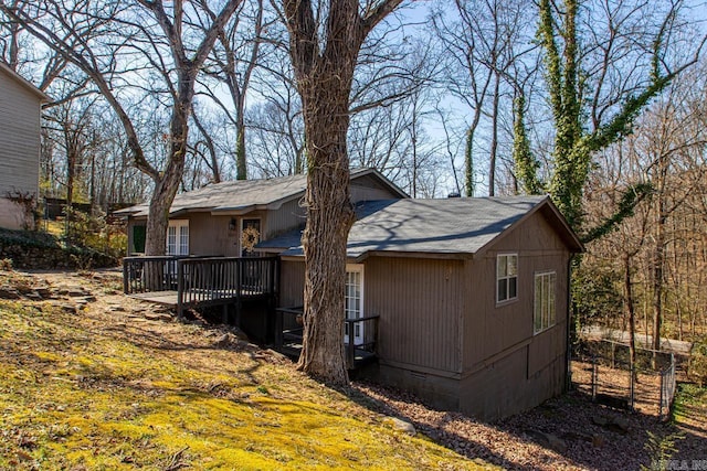 view of property exterior with crawl space and a wooden deck