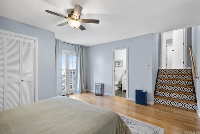 bedroom featuring a ceiling fan, baseboards, light wood-style floors, a closet, and ensuite bath