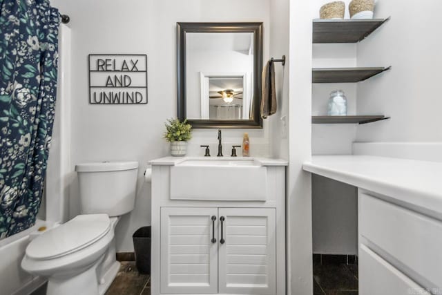 bathroom featuring toilet, a shower with shower curtain, and vanity