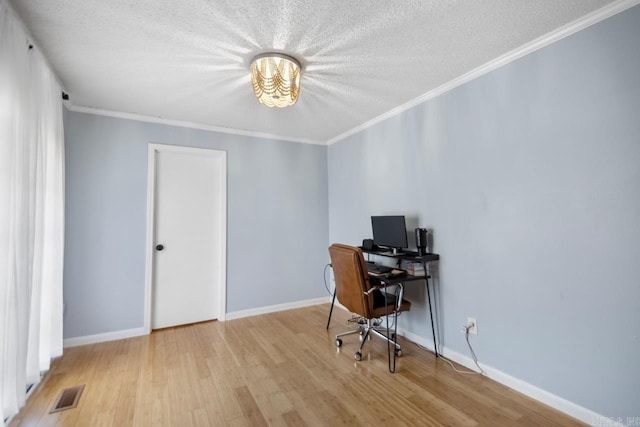 office space with visible vents, crown molding, a textured ceiling, and wood finished floors