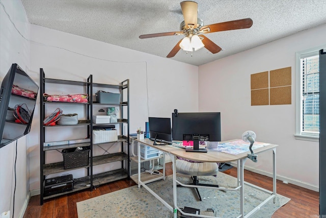 office area with a ceiling fan, a textured ceiling, baseboards, and wood finished floors