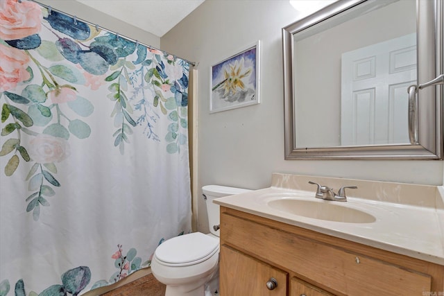 bathroom featuring toilet, a shower with curtain, and vanity