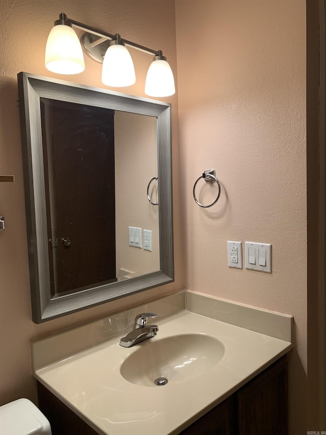 bathroom with toilet and vanity