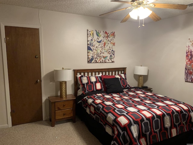 bedroom featuring a ceiling fan, carpet flooring, and a textured ceiling