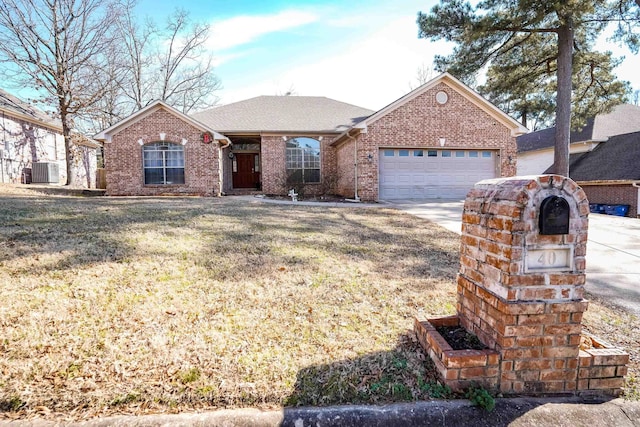 single story home with a garage, driveway, brick siding, and central AC unit