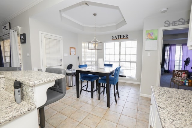 dining room with plenty of natural light, ornamental molding, and a raised ceiling