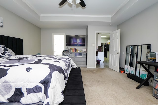 bedroom featuring freestanding refrigerator, a raised ceiling, light carpet, and ceiling fan