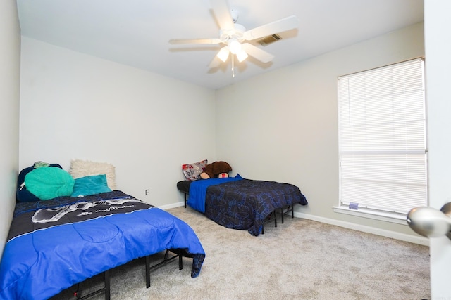 bedroom featuring visible vents, carpet floors, a ceiling fan, and baseboards