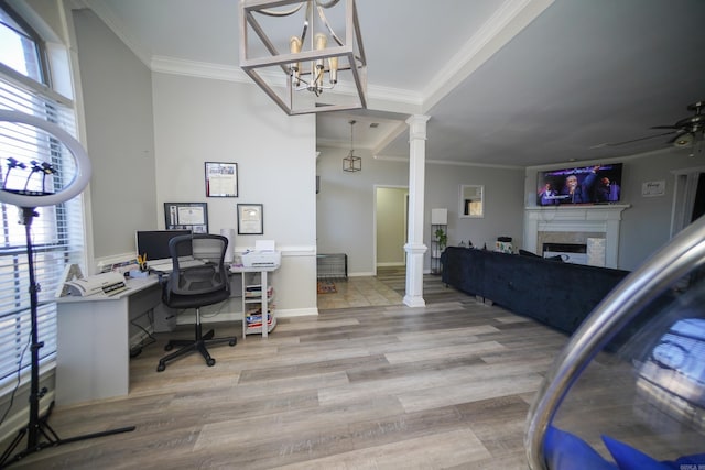 office with crown molding, a healthy amount of sunlight, a fireplace, and ornate columns