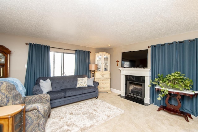 carpeted living area featuring a textured ceiling, a tile fireplace, and baseboards