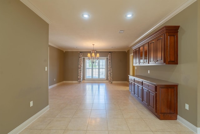 interior space with a chandelier, light tile patterned floors, baseboards, and crown molding