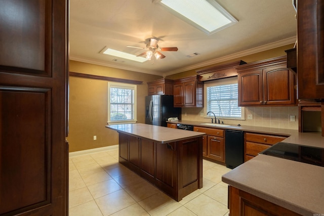 kitchen featuring tasteful backsplash, ornamental molding, a sink, ceiling fan, and black appliances