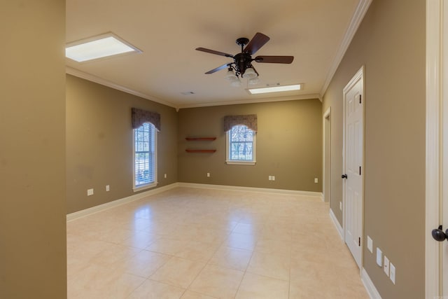 empty room featuring a ceiling fan, baseboards, and crown molding