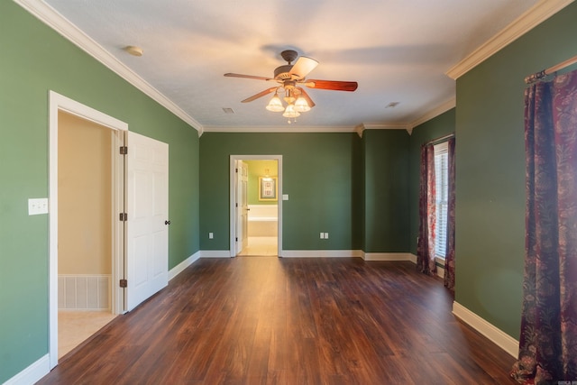 spare room with ornamental molding, visible vents, and wood finished floors