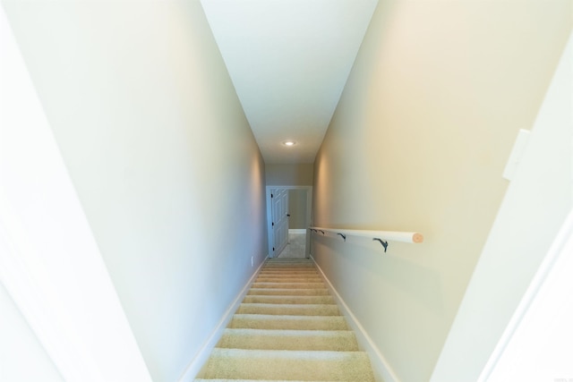 stairs featuring carpet and baseboards