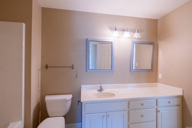bathroom featuring toilet and vanity