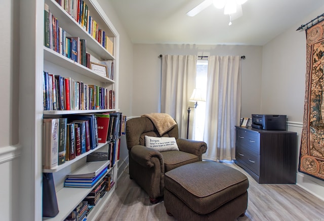 sitting room featuring a ceiling fan and wood finished floors