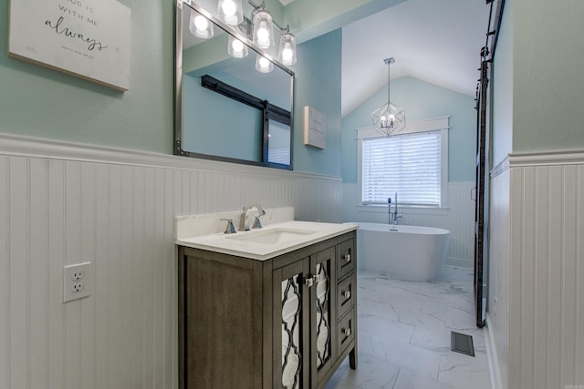 full bathroom with visible vents, wainscoting, marble finish floor, a freestanding bath, and vanity