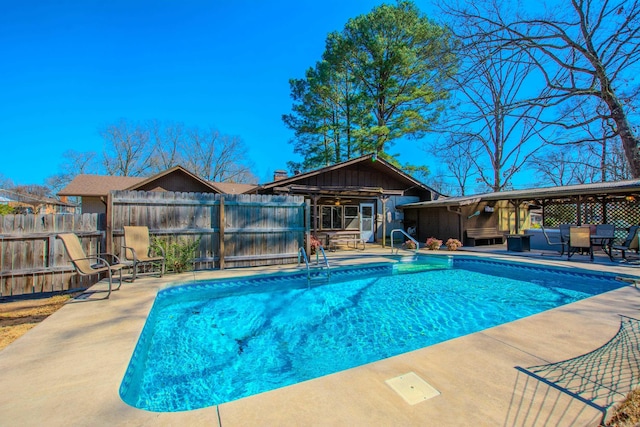 view of swimming pool featuring a patio area, fence, and a fenced in pool