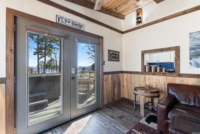 doorway featuring wooden walls, wooden ceiling, wood finished floors, french doors, and beam ceiling