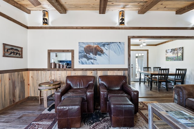 living room with wood ceiling, wood walls, beam ceiling, and wood finished floors