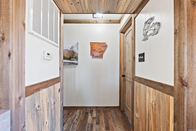 hall featuring wooden ceiling, wood finished floors, and visible vents