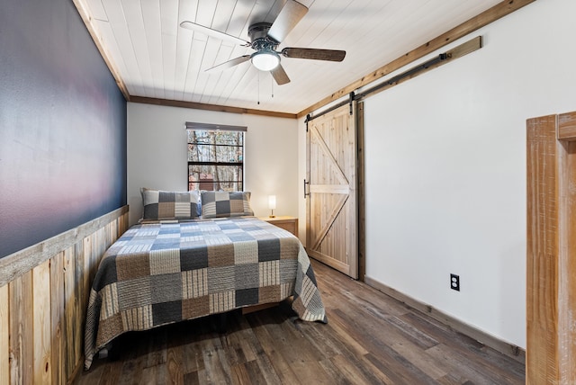 bedroom featuring crown molding, a barn door, wood ceiling, ceiling fan, and wood finished floors