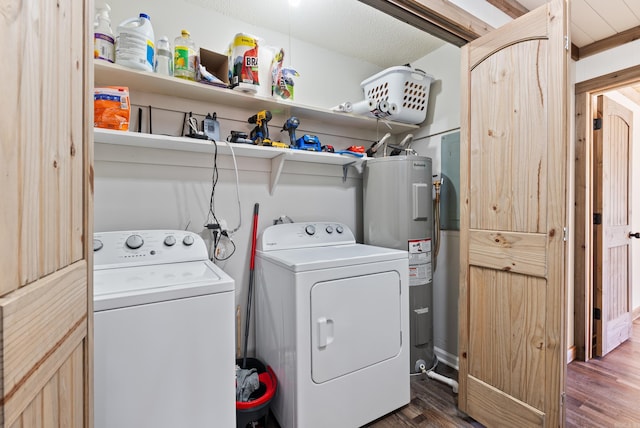 washroom featuring wood finished floors, laundry area, water heater, and separate washer and dryer