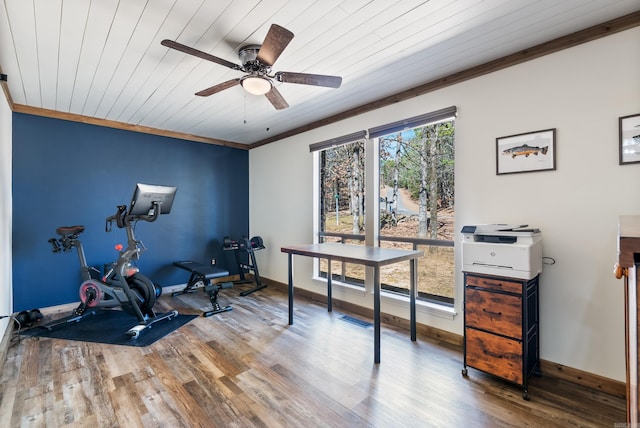 workout area with baseboards, wood ceiling, ceiling fan, ornamental molding, and wood finished floors