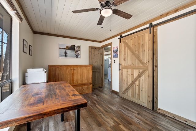 dining room featuring dark wood-style floors, a barn door, wooden ceiling, and ornamental molding