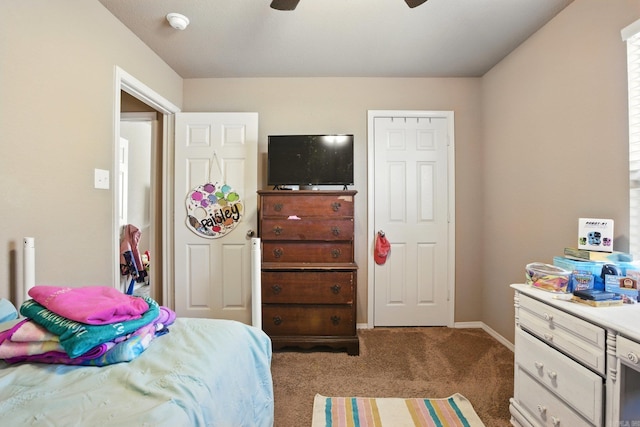 carpeted bedroom featuring ceiling fan and baseboards