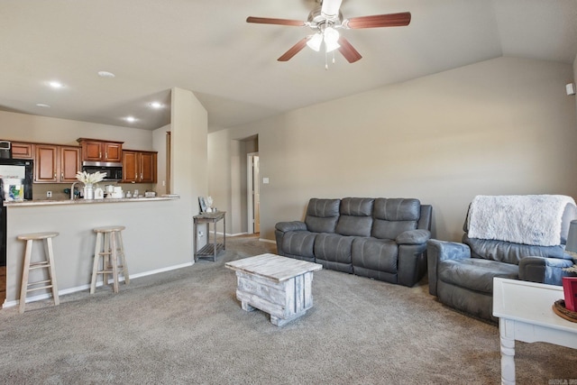 carpeted living area with baseboards, vaulted ceiling, a ceiling fan, and recessed lighting