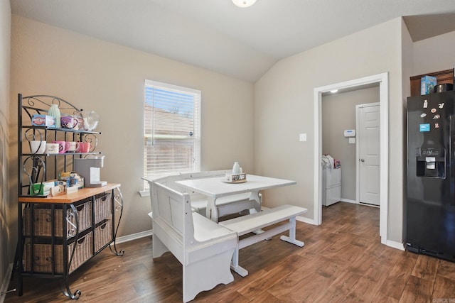 dining area with vaulted ceiling, wood finished floors, and baseboards