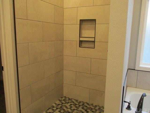 full bath with a tile shower and a bath