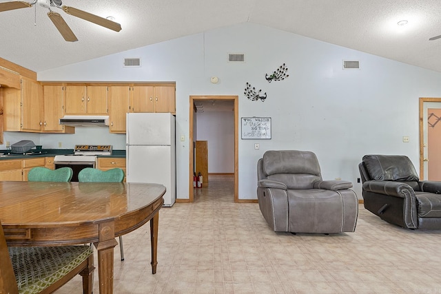 kitchen with freestanding refrigerator, under cabinet range hood, visible vents, and electric range