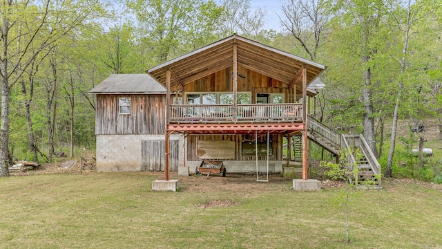 back of house with stairs, a wooded view, a lawn, and a wooden deck